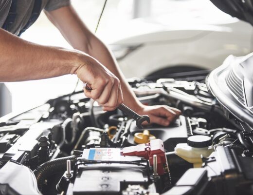 Car service worker repairing vehicle